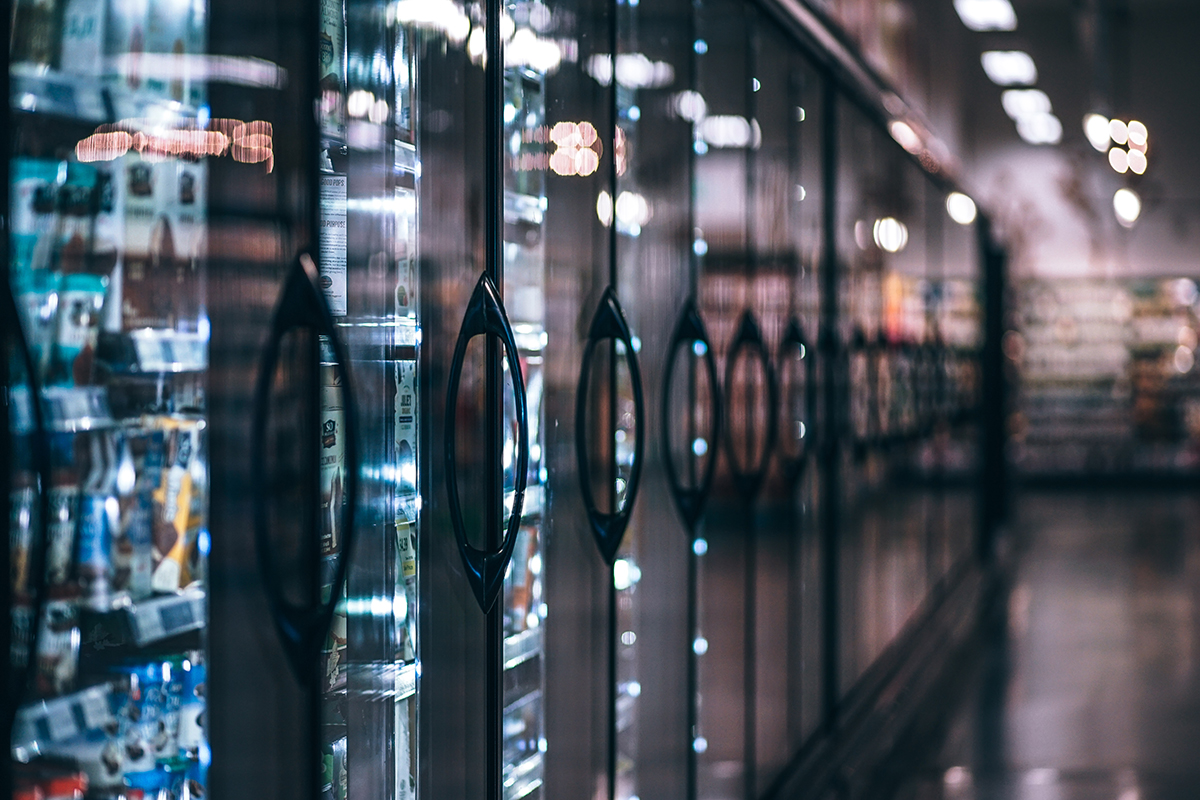 Frozen section, refrigerators with frozen products in a grocery store.